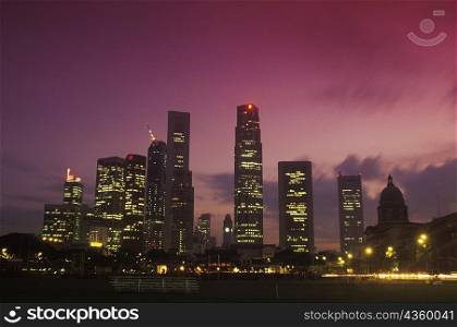 Skyscrapers in a city lit up at night