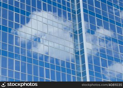 Skyscrapers with a clouds reflection