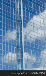 Skyscrapers with clouds reflection