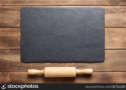 slate stone at rustic wooden plank board table background, top view
