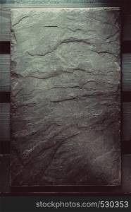 slate stone at wooden background texture
