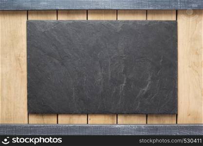 slate stone at wooden surface as background texture
