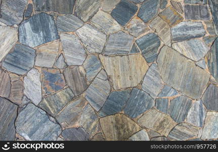 Slate stone floor and wall texture in random size pattern background.