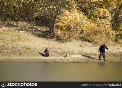 Slavyansk-na-Kubani, Russia - September 9, 2016: Fishermen on the bank of the river in autumn. Fishing the bait. Autumn scenery on the river.. Fishermen on the bank of the river in autumn. Fishing the bait.