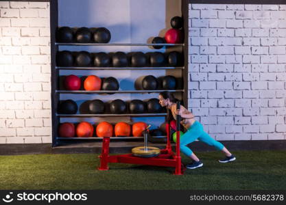 sled push woman pushing weights workout exercise