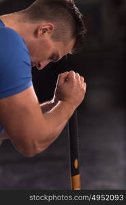 Sledgehammer Tire Hits young muscular man workout at gym with hammer and tractor tire