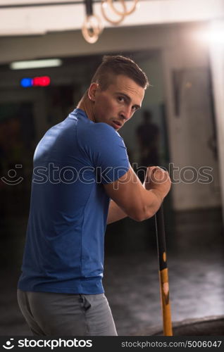 Sledgehammer Tire Hits young muscular man workout at gym with hammer and tractor tire