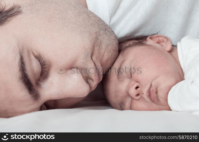 Sleep baby with dad, close up faces