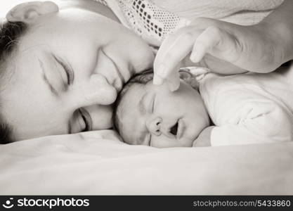 Sleep baby with mom, closeup faces