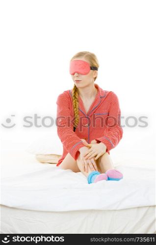 Sleep bedroom accessories concept. Sleepy woman wearing pink eye band and pajamas.. Sleepy woman wearing pink eye band