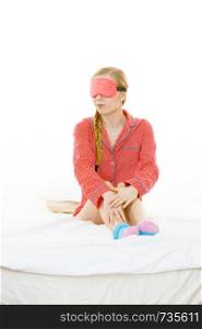 Sleep bedroom accessories concept. Sleepy woman wearing pink eye band and pajamas.. Sleepy woman wearing pink eye band