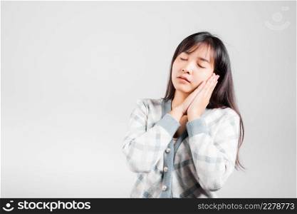 Sleep woman pretended emotions sleeping tired eyes closed dreaming with hands together near face, Portrait Asian beautiful young female sleep studio shot isolated on white background with copy space