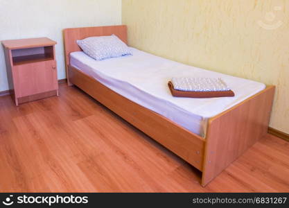 Sleeper - a bed and a bedside table in the interior of the room, close-up