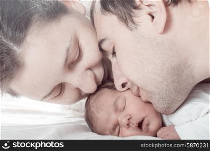Sleeping baby with mom and dad, closeup faces