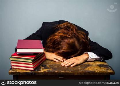 Sleeping Businesswoman with stack of books