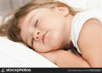 Sleeping little girl on bed