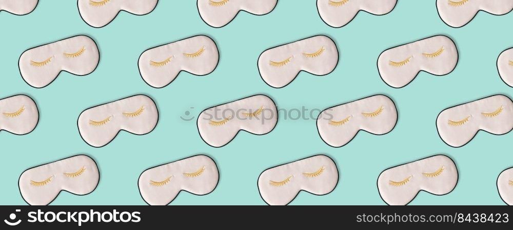 Sleeping mask pattern. Pink silk sleeping masks for eyes on pastel blue background. Creative Top view Flat lay. Concept eye protection from light for good sleep and melatonin production.