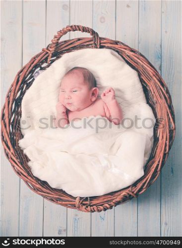 Sleeping newborn baby on a soft white blanket. The newborn baby