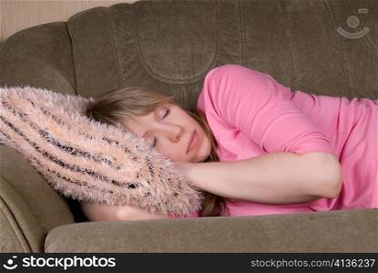 Sleeping pretty woman at sofa