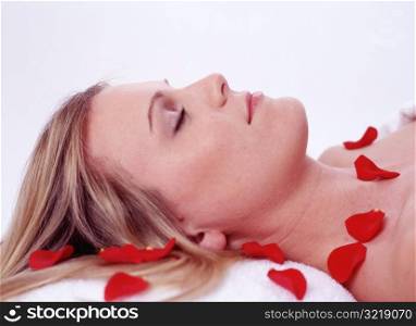 Sleeping Woman&acute;s Face Surrounded by Rose Petals