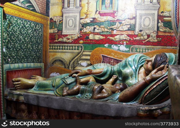 Sleeping woman with child in Wewurukannala Vihara, Sri Lanka