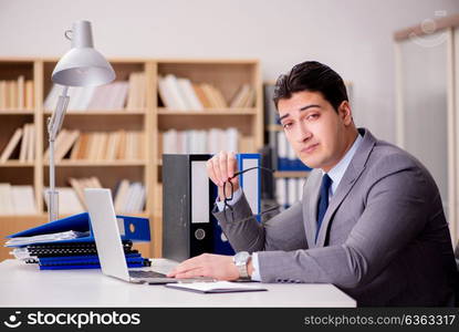 Sleepy businessman working in office