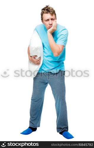 Sleepy man in pajamas with a pillow in his hand on a white backg. Sleepy man in pajamas with a pillow in his hand on a white background