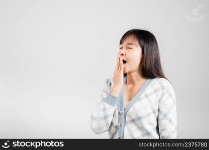 Sleepy woman closed eyes emotions tired and sleepy her yawning cover mouth open by hand, Portrait Asian beautiful young female sleep and energy studio shot isolated on white background with copy space