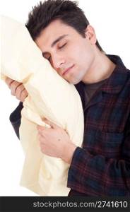 sleepy young man in pajamas holding pillow isolated on white background