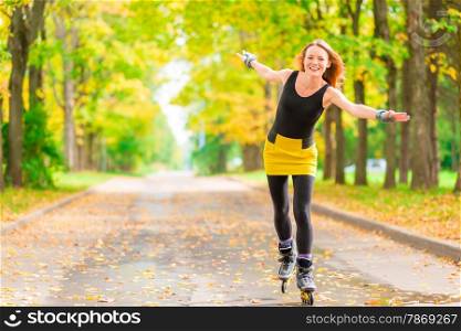 slender red-haired girl on roller skates rolling