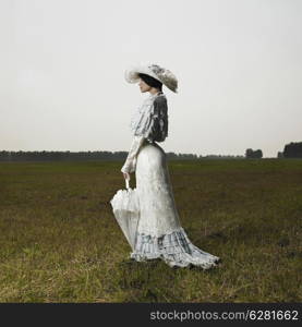 Slender woman in vintage dress for promenade