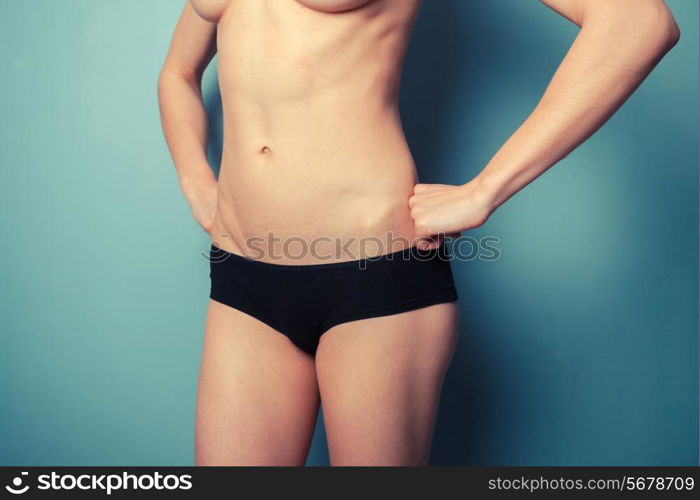 Slender young woman is wearing black underwear