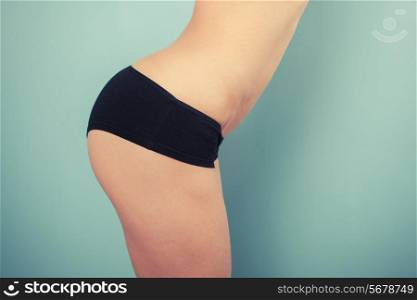 Slender young woman is wearing black underwear