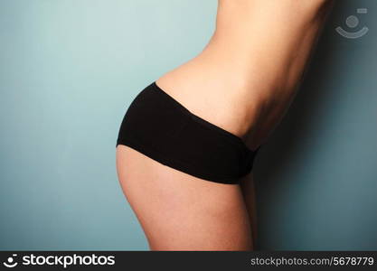 Slender young woman is wearing black underwear