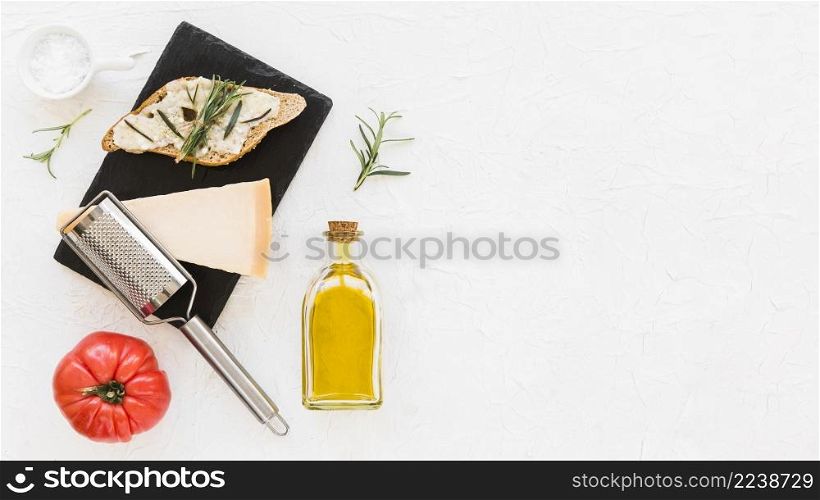 slice bread with cheese rosemary tomato white backdrop