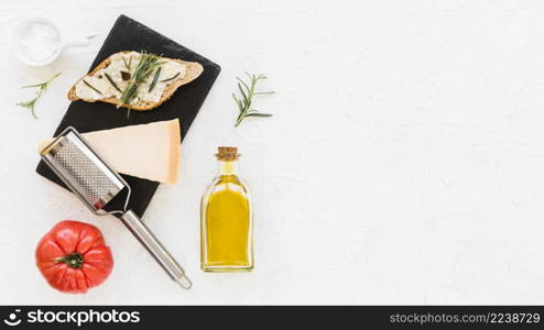 slice bread with cheese rosemary tomato white backdrop