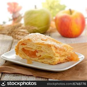 Slice Of An Apple Strudel In A White Dish
