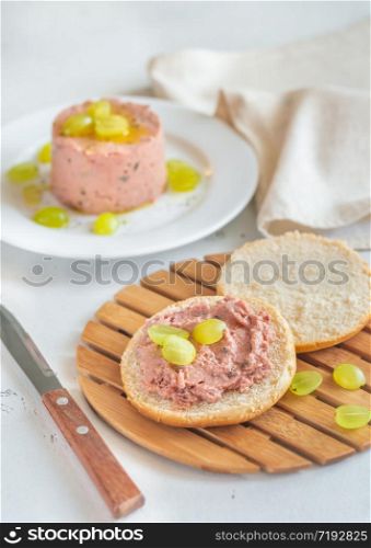 Slice of bread with pate with glass of wine on the wooden board