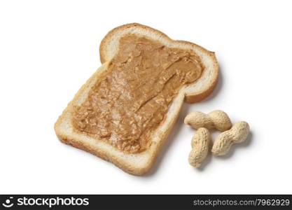Slice of bread with peanut butter on white background