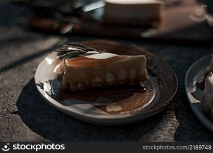 Slice of cheesecake with caramel sauce on plate. . Slice of cheesecake with caramel sauce