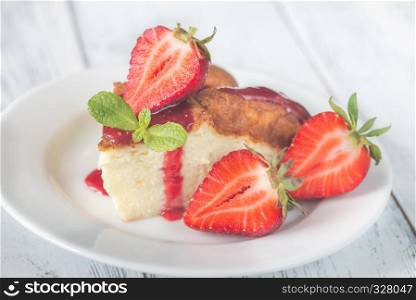 Slice of cheesecake with fresh strawberries