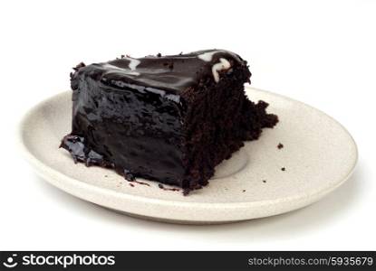 Slice of chocolate cake isolated on white