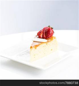 Slice of delicious cake, strawberry topping on dish