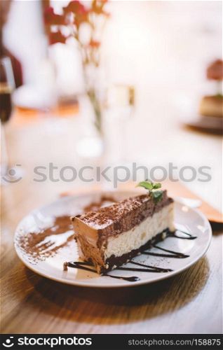 Slice of delicious cheesecake served on a decorated plate. Restaurant serving. Sweet meal.. Slice of cheesecake served on a decorated plate.