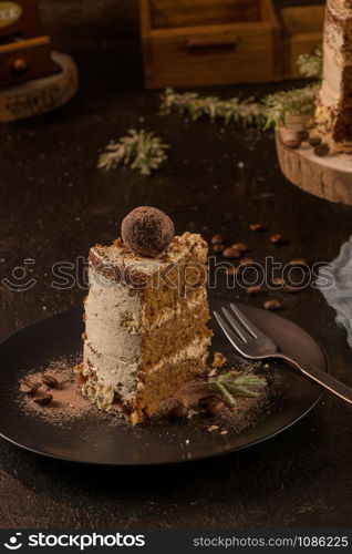 Slice of delicious naked coffee and hazelnuts cake on table rustic wood kitchen countertop.