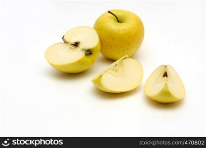 slice of juicy apple with defocused yellow apples at the distance