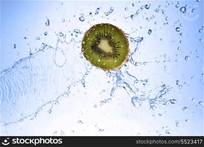 slice of kiwi in water with bubbles