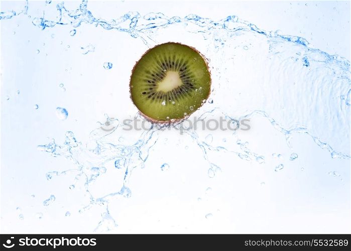 slice of kiwi in water with bubbles