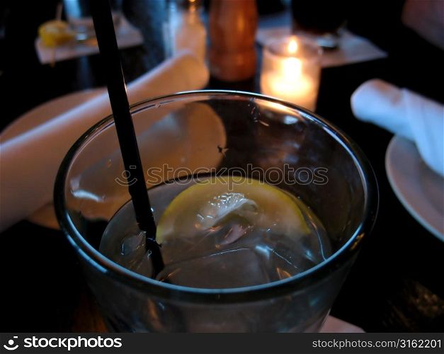 Slice of lemon in water on table