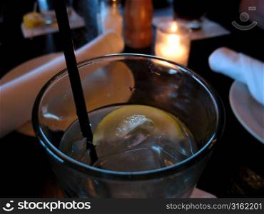 Slice of lemon in water on table